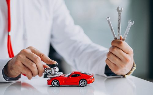 Car doctor with stethoscope in a car showroom