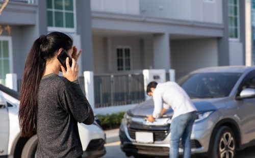 Caucasian Woman Driver Making Phone Call To Insurance Agent After Traffic Accident. Accident. Car insurance an non-life insurance concept.